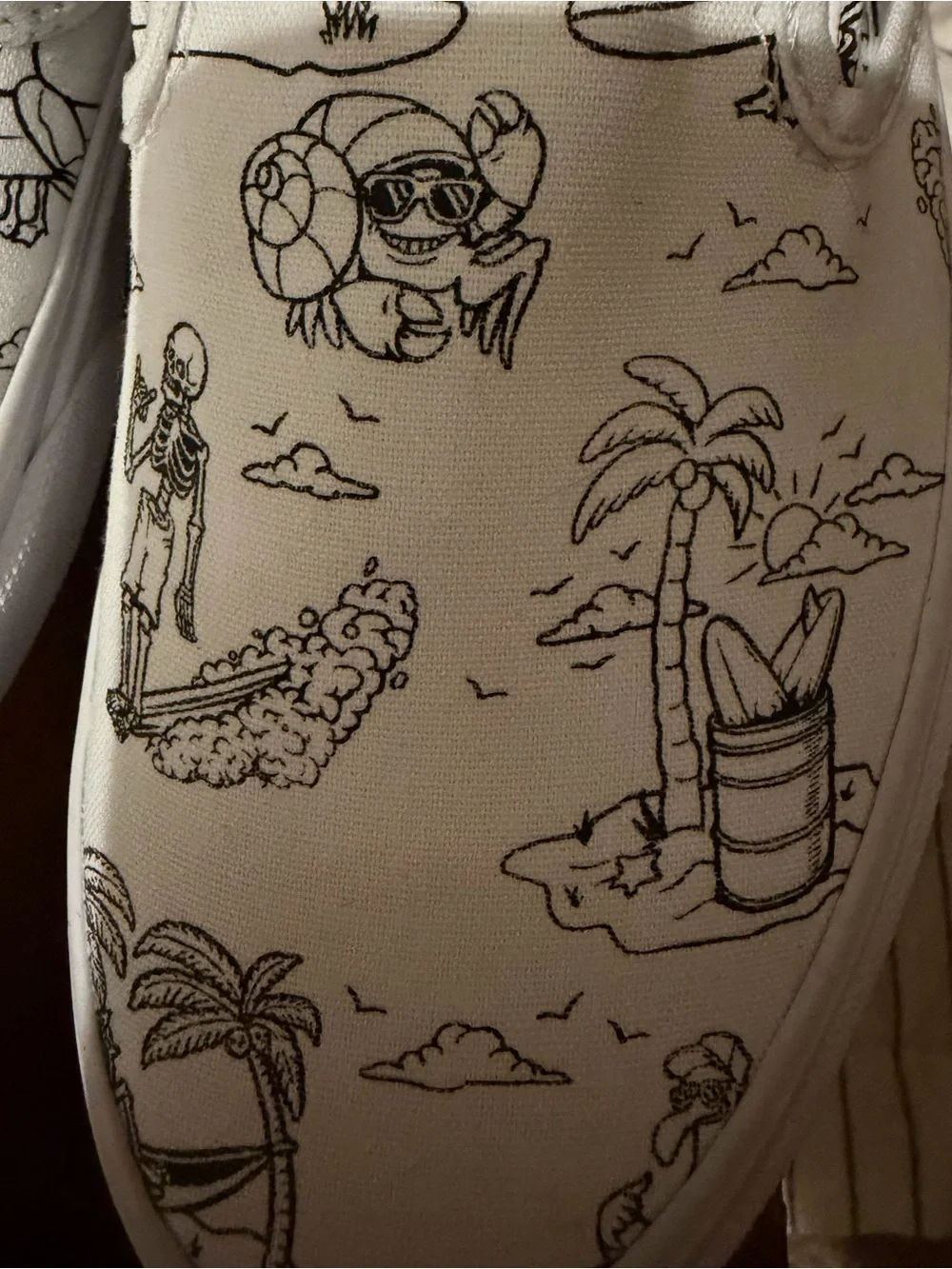 Vans White Slip-On Sneakers with Black skeleton doodles